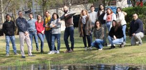 Staff and students of the lab, close to a pond in the university yard